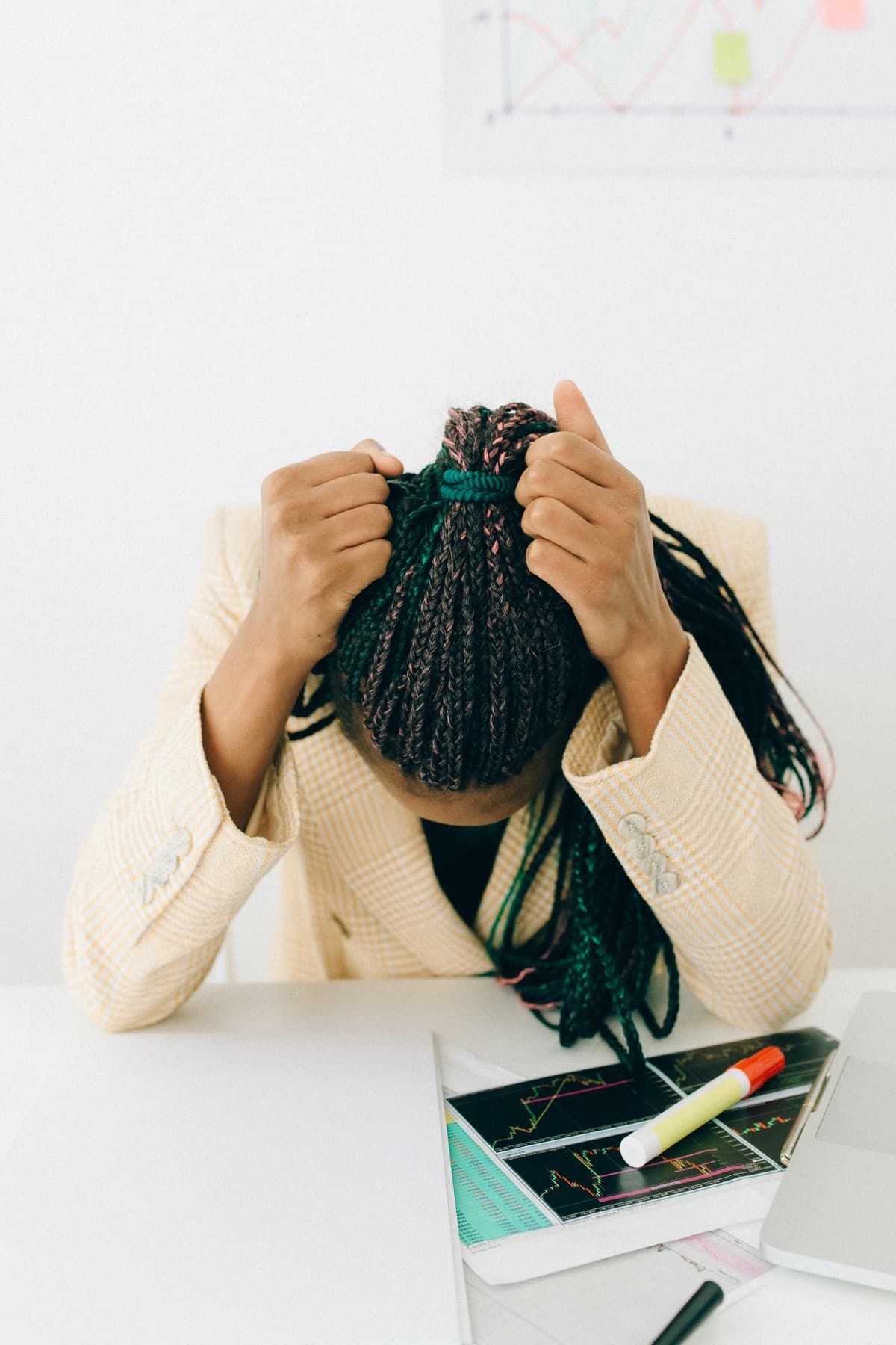 Employee experiencing financial stress at their workplace desk